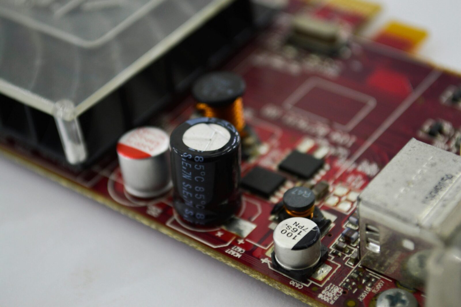 Detailed macro shot of a circuit board highlighting capacitors, chips, and circuits.